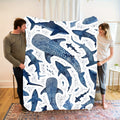 A Soft And Cozy Flannel Blanket Featuring a Marine Blue Whale Shark Theme, Perfect for Home Use.
